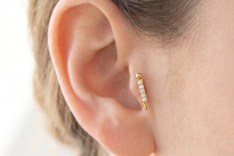 Golden Tragus Piercing